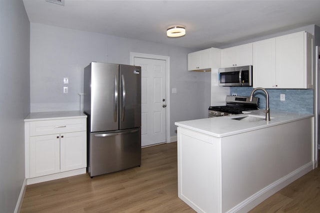 30 Pinetree Dr, Villas, NJ 08251 - kitchen with stainless steel appliances, light wood-style flooring, a sink, and tasteful backsplash