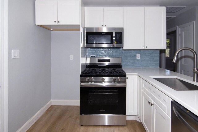 30 Pinetree Dr, Villas, NJ 08251 - kitchen with appliances with stainless steel finishes, a sink, light wood-type flooring, baseboards, and backsplash