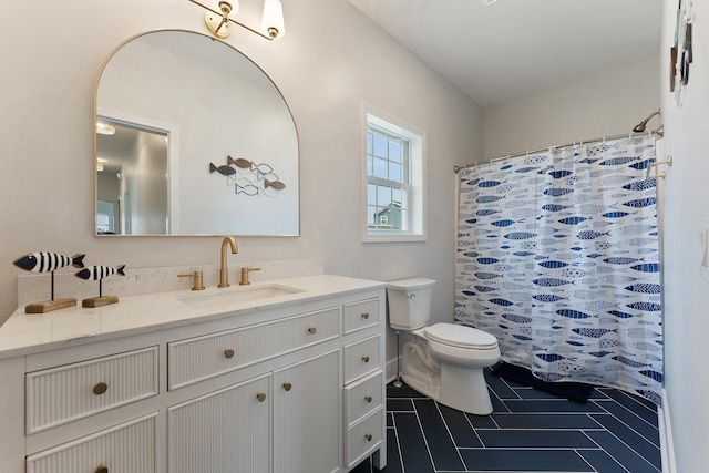 bathroom featuring tile patterned flooring, a shower with shower curtain, vanity, and toilet