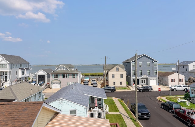 exterior space with a residential view and a water view