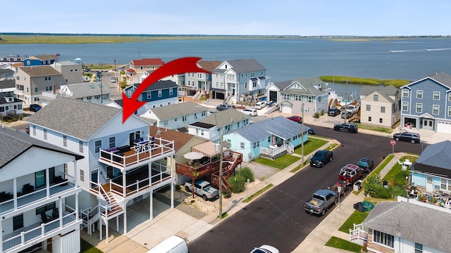 birds eye view of property featuring a residential view and a water view