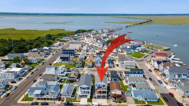 bird's eye view featuring a water view and a residential view