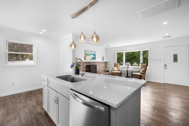 121 Roslyn Ave, North Cape May, NJ 08204 - kitchen featuring dishwasher, a brick fireplace, hanging light fixtures, light stone counters, and recessed lighting
