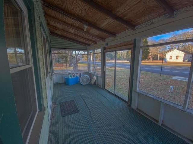 unfurnished sunroom with wooden ceiling and vaulted ceiling with beams