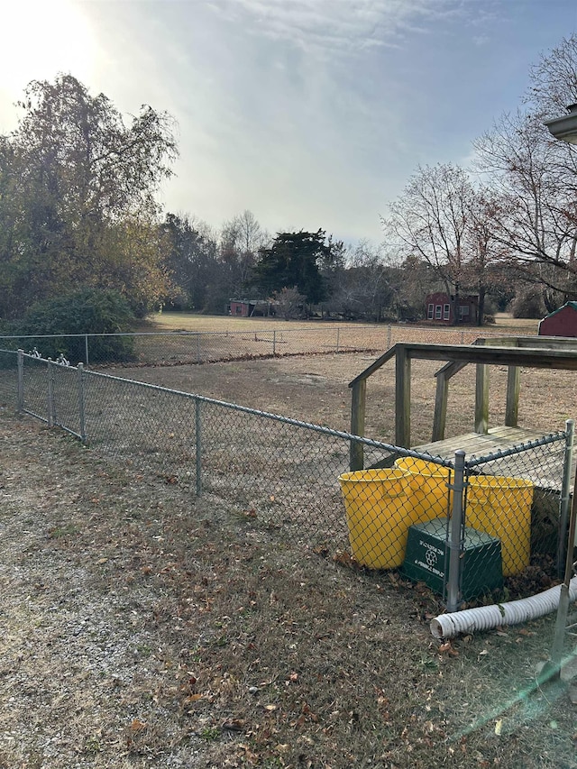 view of yard with a rural view and fence