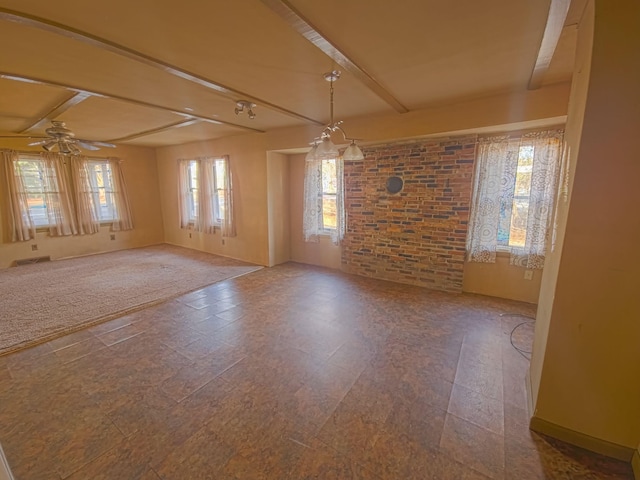 unfurnished room featuring beam ceiling, brick wall, and ceiling fan