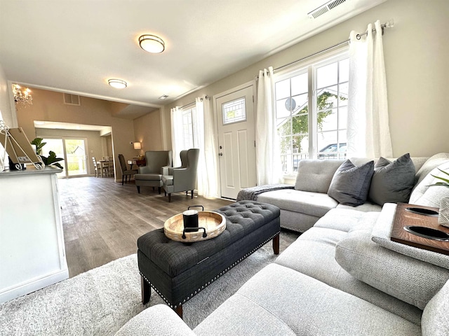 living room featuring an inviting chandelier and light wood-type flooring