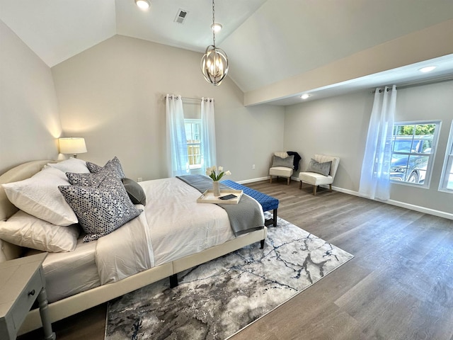 bedroom featuring a chandelier, vaulted ceiling, and wood-type flooring