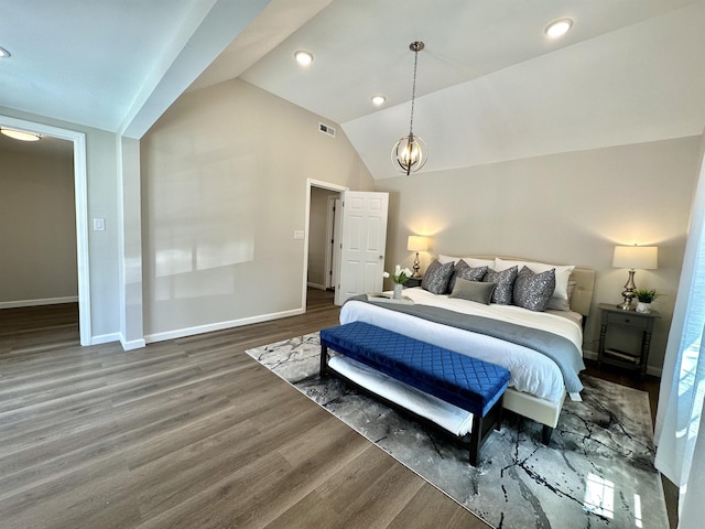 bedroom with dark hardwood / wood-style flooring, a chandelier, and lofted ceiling