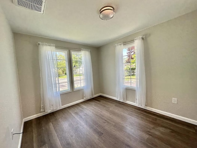 spare room with dark hardwood / wood-style floors