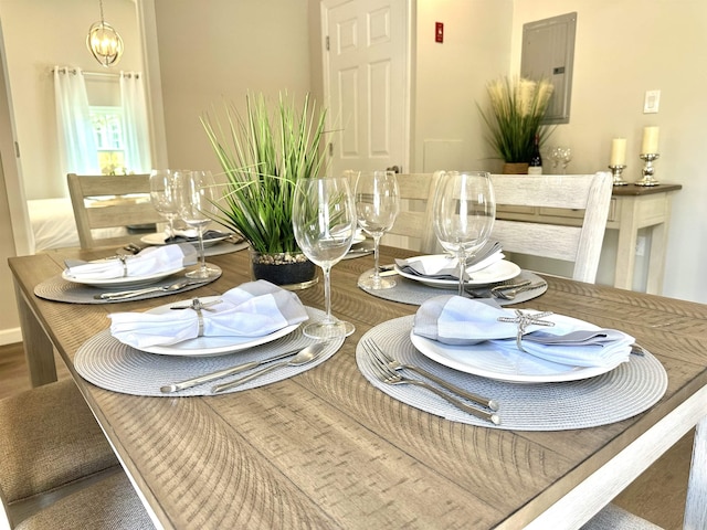 dining space featuring electric panel and hardwood / wood-style flooring