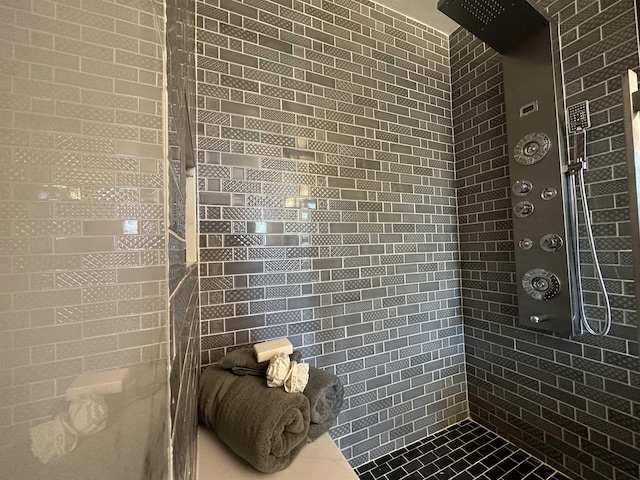 bathroom with a tile shower