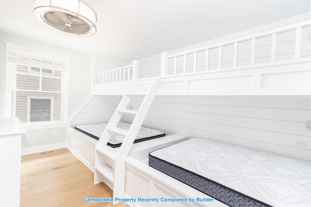 bedroom featuring visible vents, light wood-style flooring, and baseboards