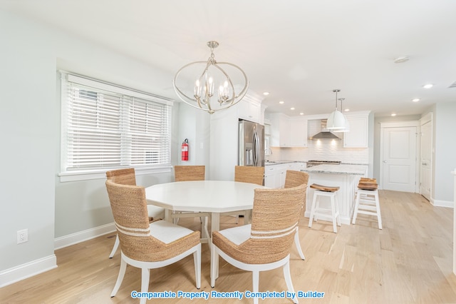 dining room with light wood-type flooring, baseboards, and recessed lighting