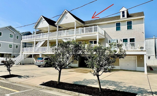 328 E 25th Ave Unit C, North Wildwood, NJ 08260 - view of property featuring stairway, concrete driveway, and a garage