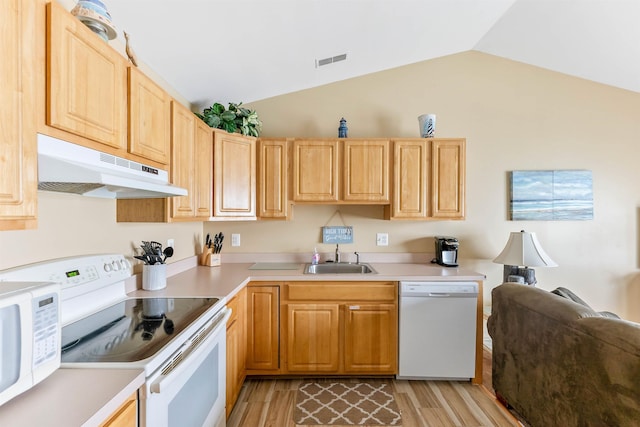 328 E 25th Ave Unit C, North Wildwood, NJ 08260 - kitchen featuring under cabinet range hood, white appliances, vaulted ceiling, light countertops, and light wood-style floors