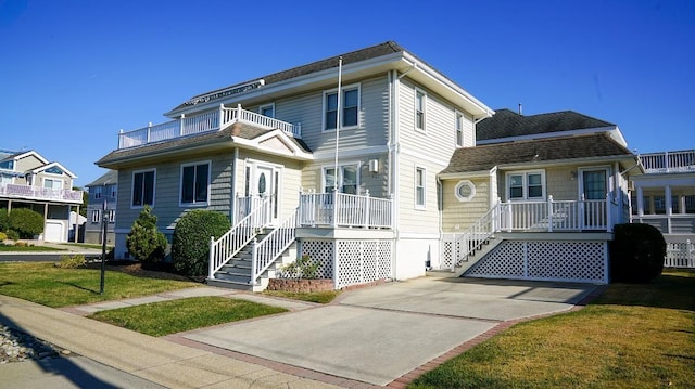 view of front of property featuring stairway and a front yard