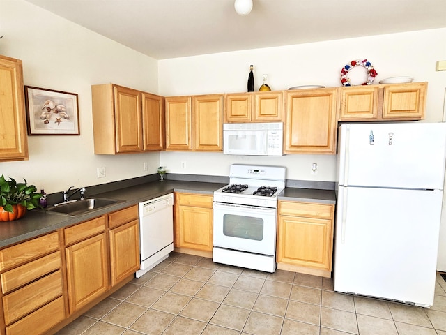 kitchen with light tile patterned floors, white appliances, and sink