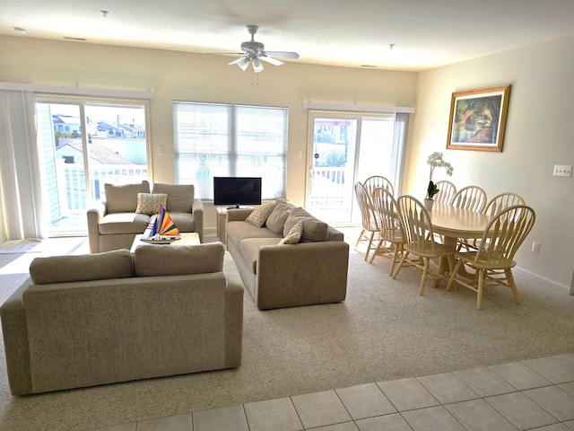 carpeted living room with ceiling fan