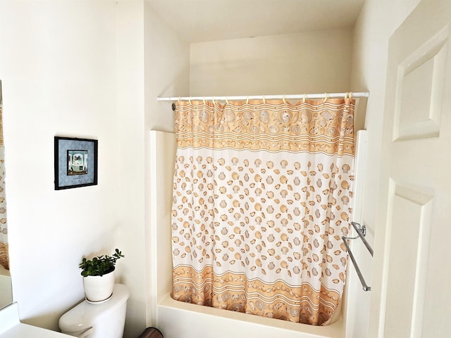 bathroom with shower / tub combo and toilet