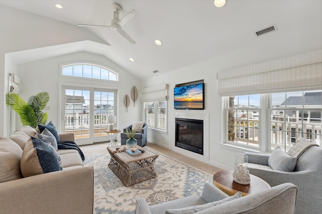 living room featuring ceiling fan, lofted ceiling, and light carpet