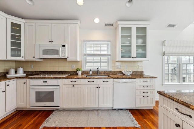 kitchen featuring sink, white appliances, white cabinets, and dark hardwood / wood-style flooring