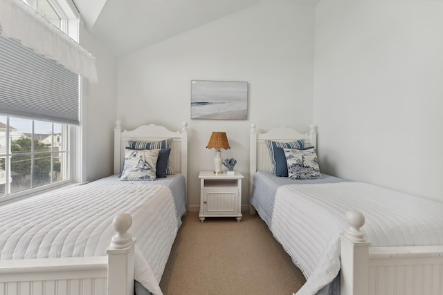 bedroom with carpet flooring and lofted ceiling