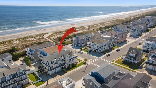 birds eye view of property with a view of the beach and a water view