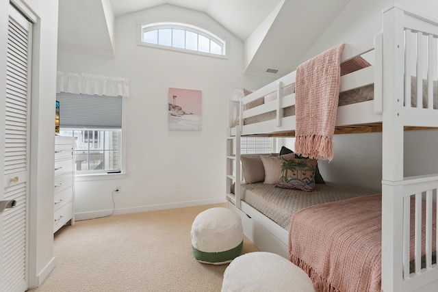 bedroom featuring light carpet, multiple windows, and vaulted ceiling