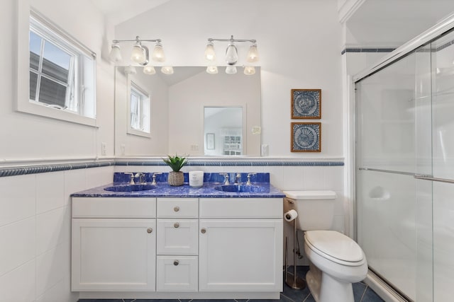 bathroom featuring toilet, tile walls, tile patterned floors, vaulted ceiling, and a shower with door