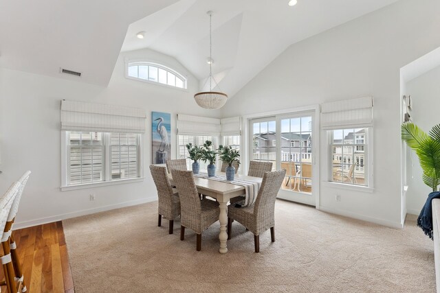 living room with ceiling fan, light carpet, and lofted ceiling