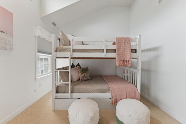 carpeted bedroom with vaulted ceiling