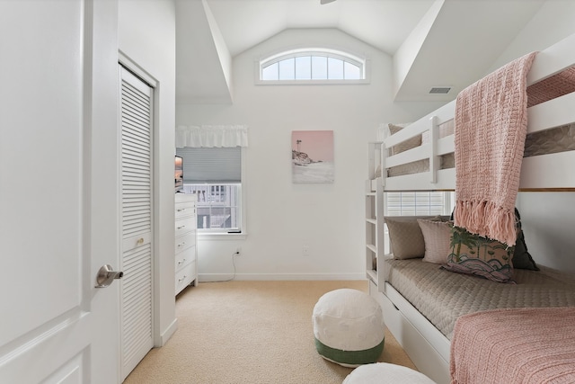 bedroom with light carpet and vaulted ceiling