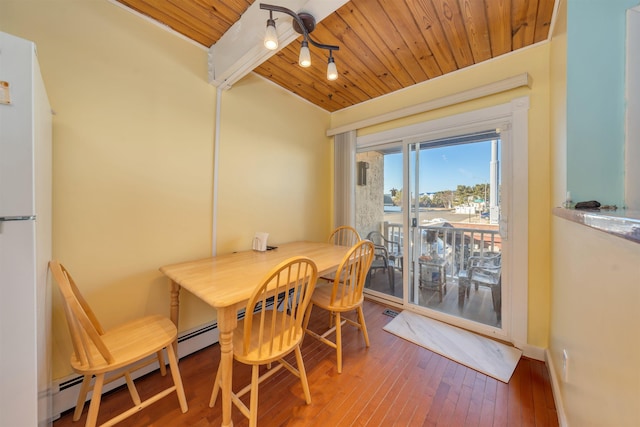 dining space featuring hardwood / wood-style floors, wooden ceiling, and a baseboard heating unit