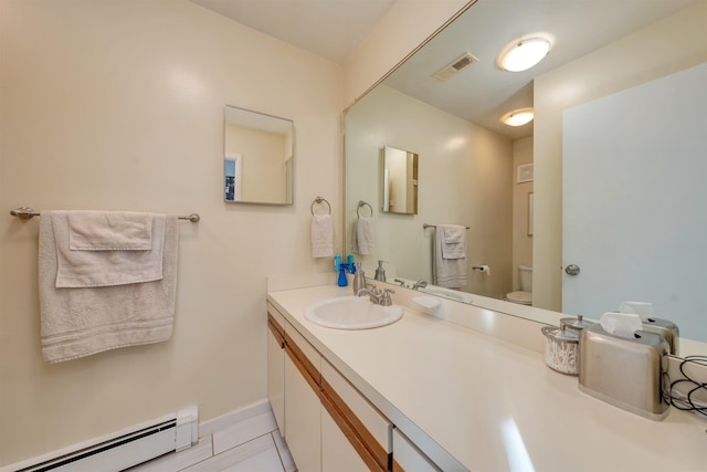 bathroom featuring vanity, tile patterned floors, toilet, and baseboard heating