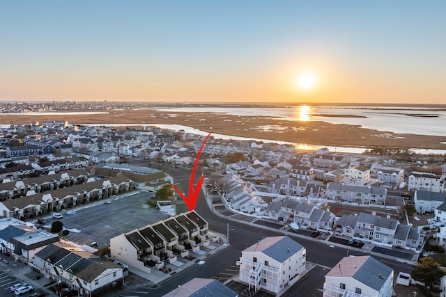 aerial view at dusk with a water view