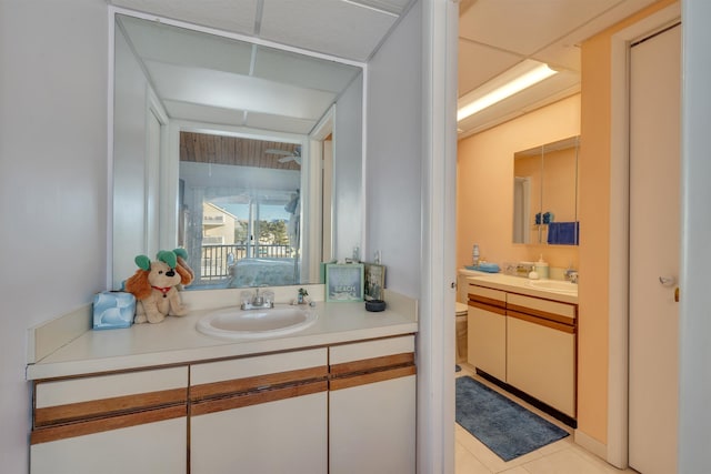 bathroom featuring tile patterned flooring, vanity, and toilet