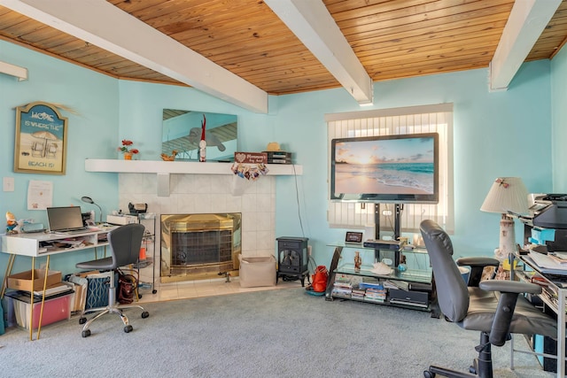 carpeted office featuring beam ceiling, wooden ceiling, and a tile fireplace