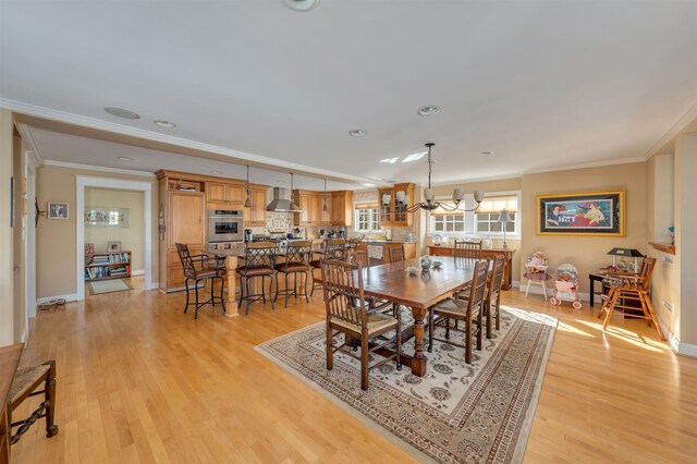 56 E 22nd St, Avalon, NJ 08202 - dining space featuring ornamental molding, light wood finished floors, a chandelier, and recessed lighting