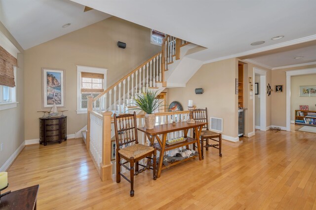 56 E 22nd St, Avalon, NJ 08202 - dining room featuring light wood-type flooring, stairs, and ornamental molding