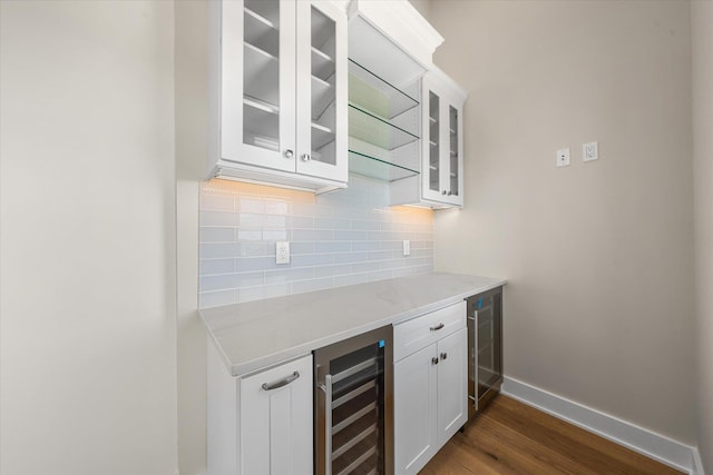 310 42nd Pl Unit 201E, Sea Isle City, NJ 08243 - bar with baseboards, wine cooler, backsplash, and dark wood-style floors