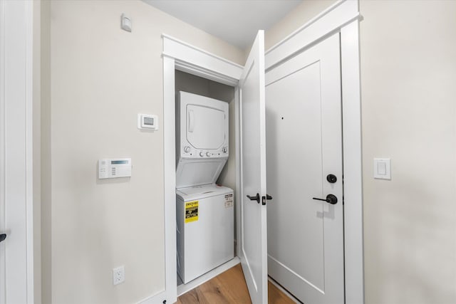 310 42nd Pl Unit 201E, Sea Isle City, NJ 08243 - laundry room with stacked washer / drying machine, light wood-style flooring, and laundry area