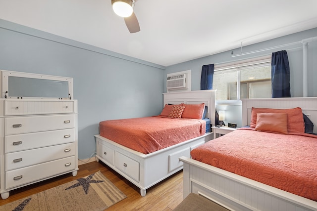 8401 Atlantic Ave # 405, Wildwood Crest, NJ 08260 - bedroom featuring light wood-style flooring, a wall mounted AC, and a ceiling fan