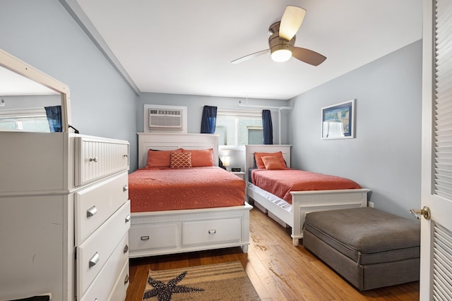 8401 Atlantic Ave # 405, Wildwood Crest, NJ 08260 - bedroom with wood finished floors, a wall mounted air conditioner, and ceiling fan