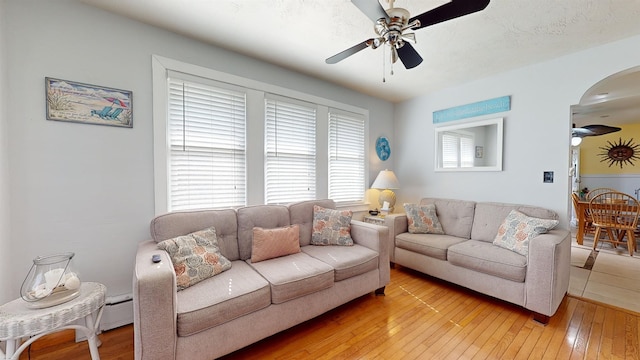 living room with ceiling fan and wood-type flooring