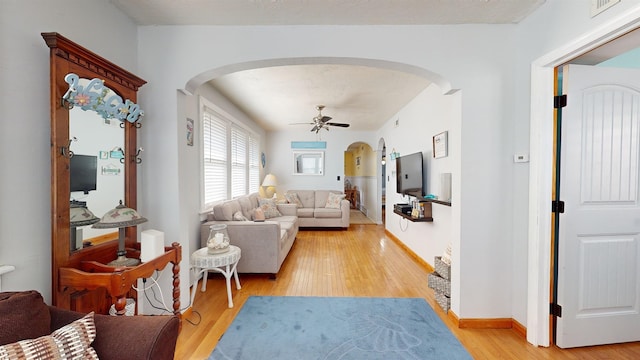 living room with light hardwood / wood-style floors and ceiling fan