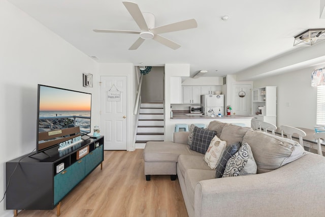 316 E 17th Ave Unit 6, North Wildwood, NJ 08260 - living room featuring stairs, light wood-style flooring, and a ceiling fan
