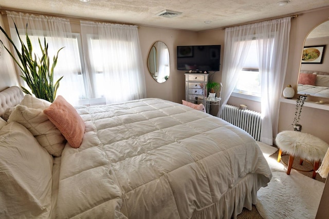 14 Lyndhurst Rd, Marmora, NJ 08223 - carpeted bedroom featuring radiator, a textured ceiling, and arched walkways