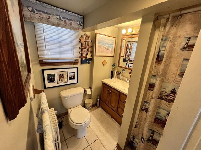 14 Lyndhurst Rd, Marmora, NJ 08223 - bathroom featuring toilet, vanity, radiator heating unit, and tile patterned flooring