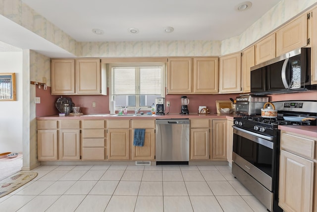 138 8th St, Avalon, NJ 08202 - kitchen featuring stainless steel appliances, light brown cabinetry, light tile patterned flooring, and light countertops